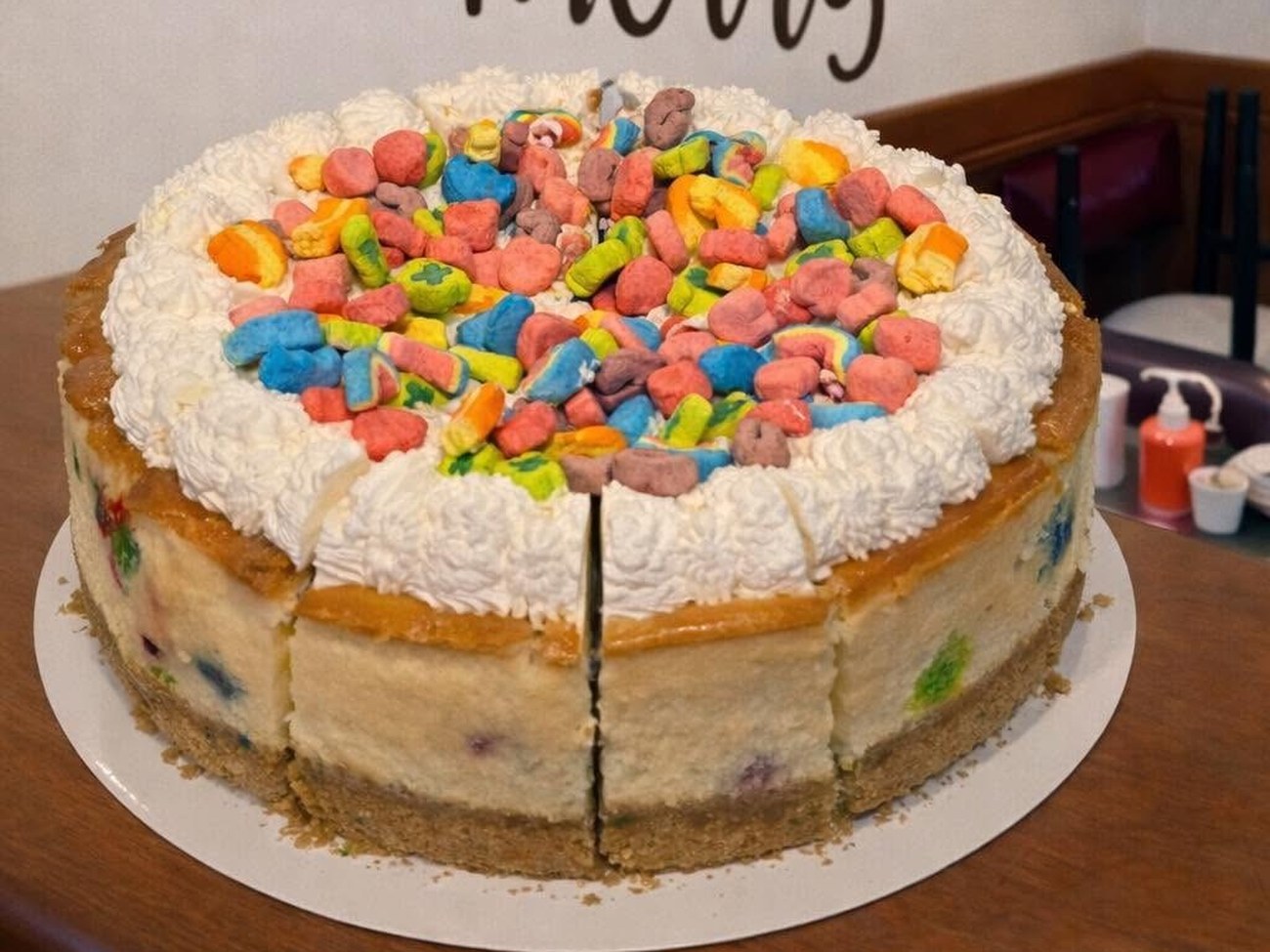 Lucky Charms cheesecake with whipped cream and marshmallow cereal